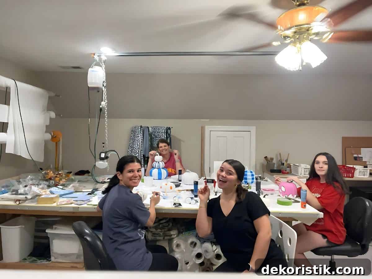 3 ladies painting pumpkins