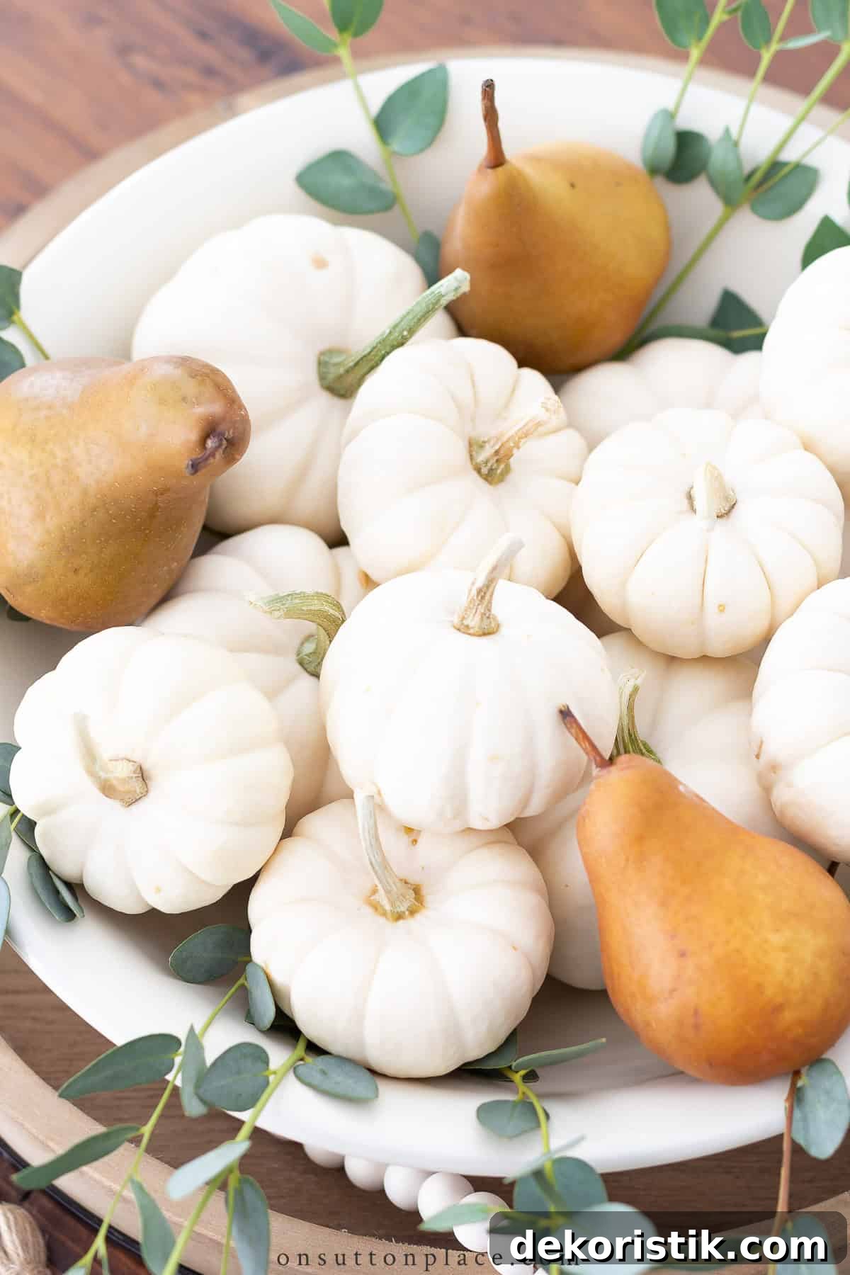 bowl of white mini pumpkins and brown pears