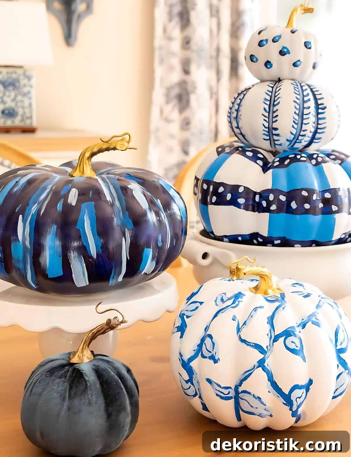 DIY Painted Pumpkin Centerpiece Ideas for Fall Decor 4 blue and white DIY painted pumpkins used as a centerpiece