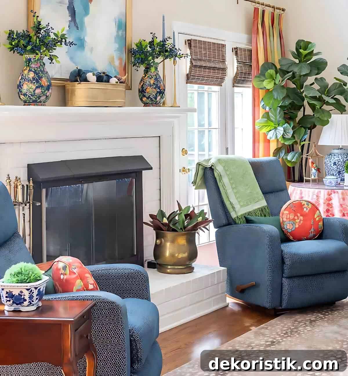 two blue recliners flanking a white brick fireplace decorated with blankets, pillows and accessories for fall