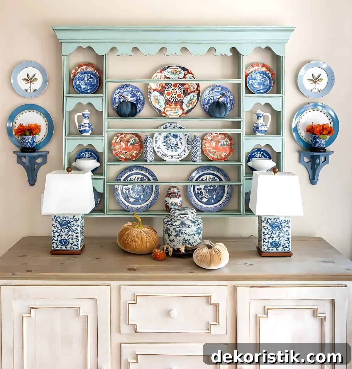 blue plate rack above a white sideboard decorated with blue and orange plates for fall