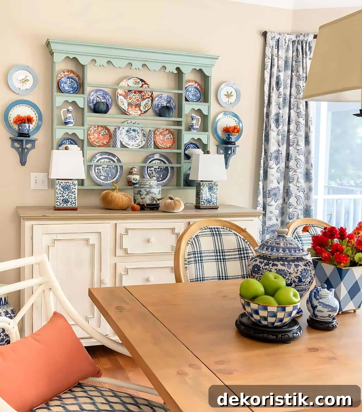 blue plate rack above a white sideboard decorated with blue and orange plates for fall