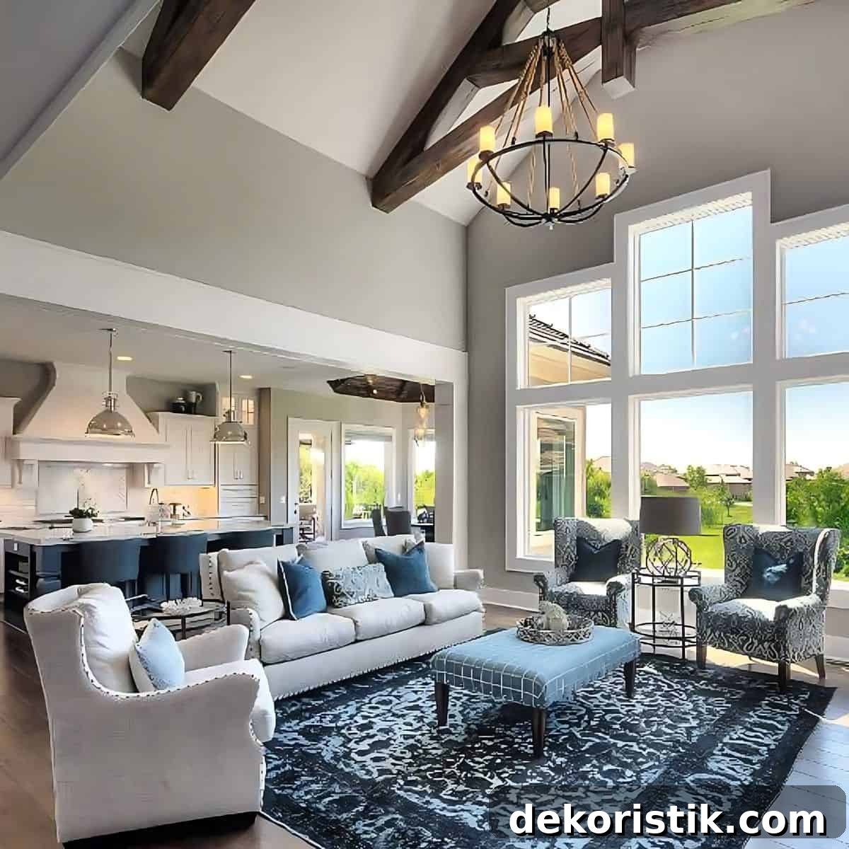 open plan great room with dark blue rug and neutral furnishings