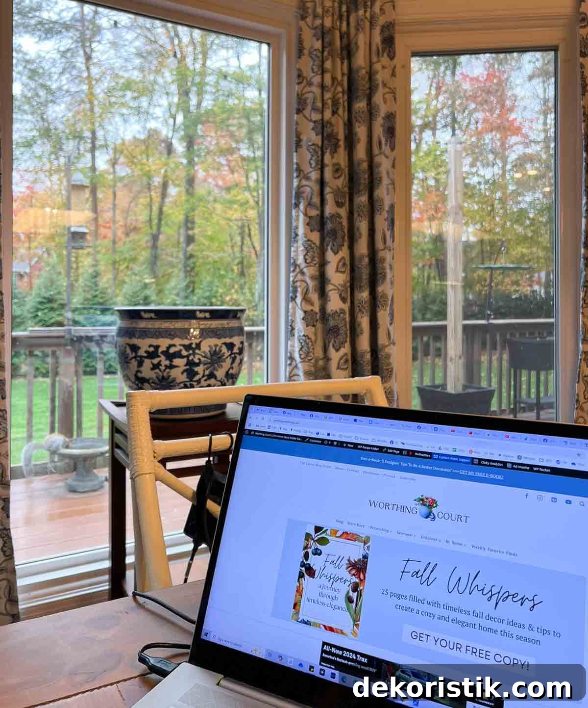 view through a bay window of fall leaves