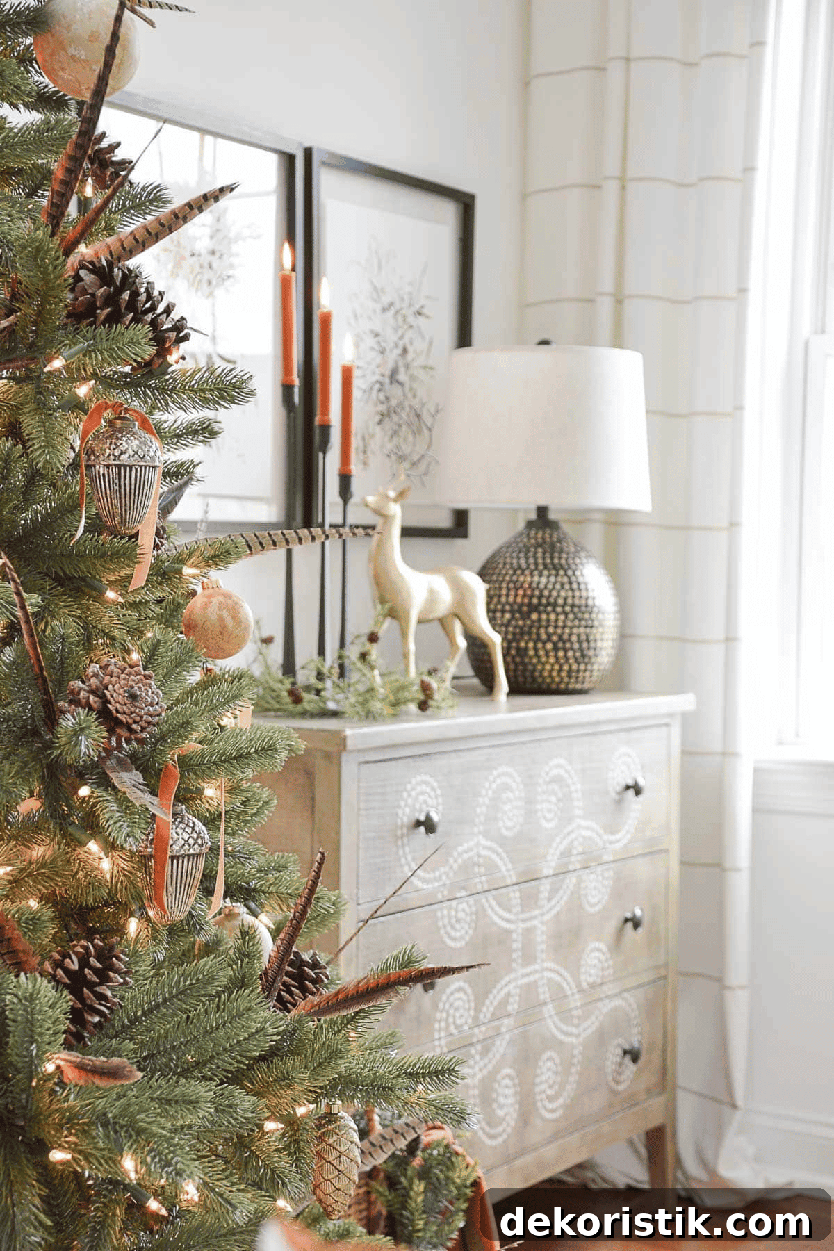 partial view of a Christmas tree beside a white chest