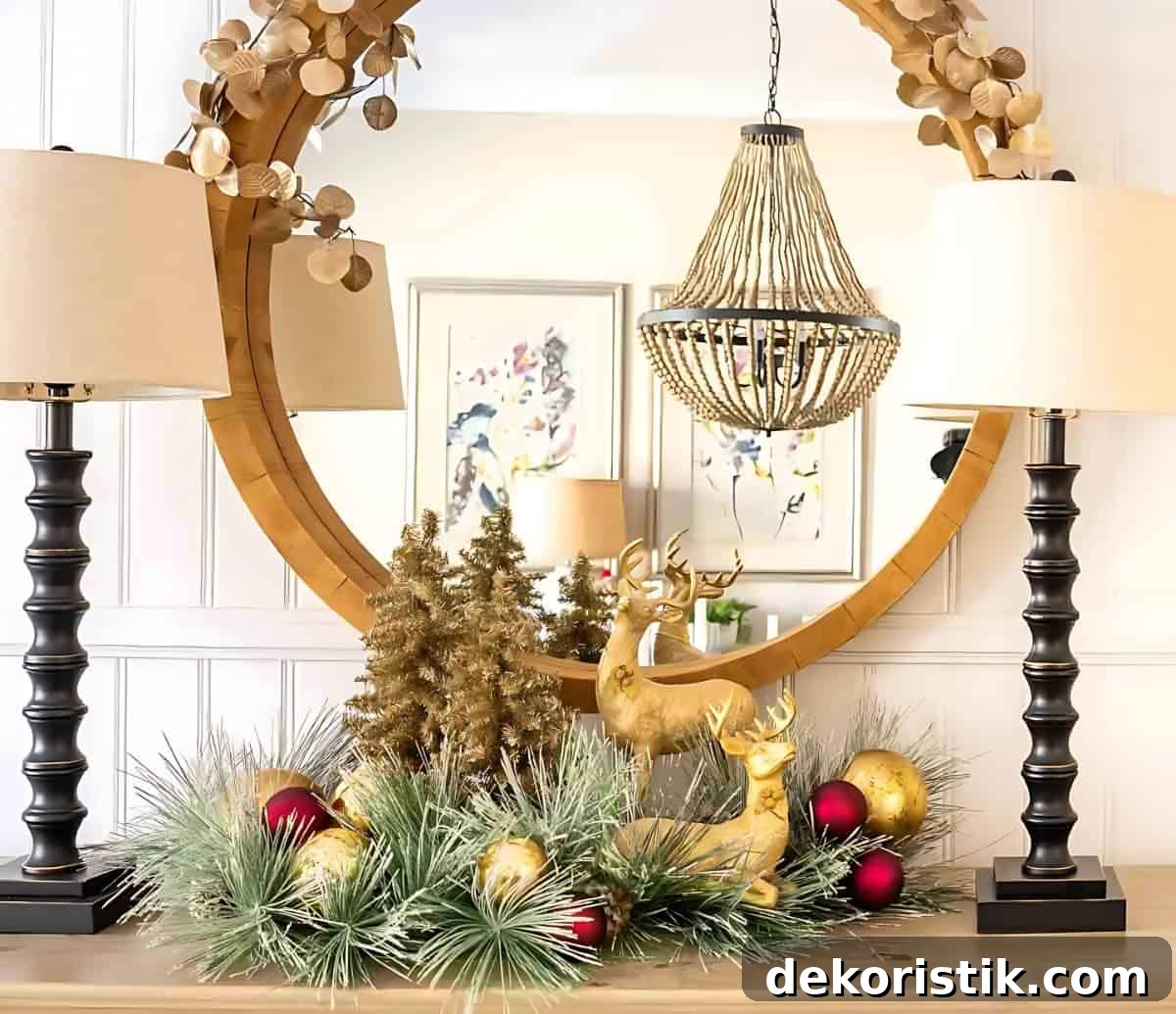 Christmas Vignette Ideas to Elevate Your Holiday Decor 13 Christmas vignette on a sideboard with gold deer and gold tinsel trees in front of a round mirror