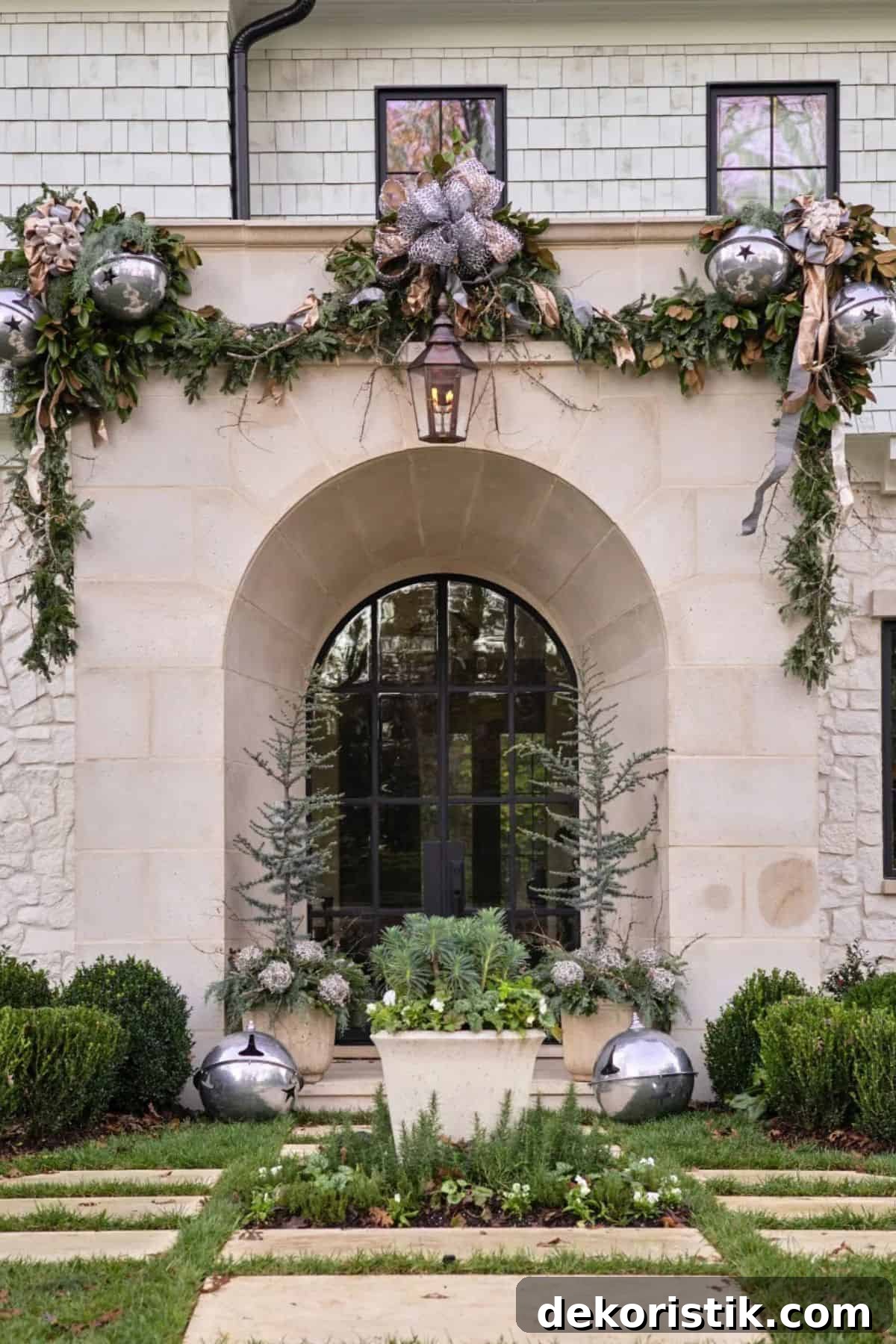 front entrance to a large home decorated for the holidays