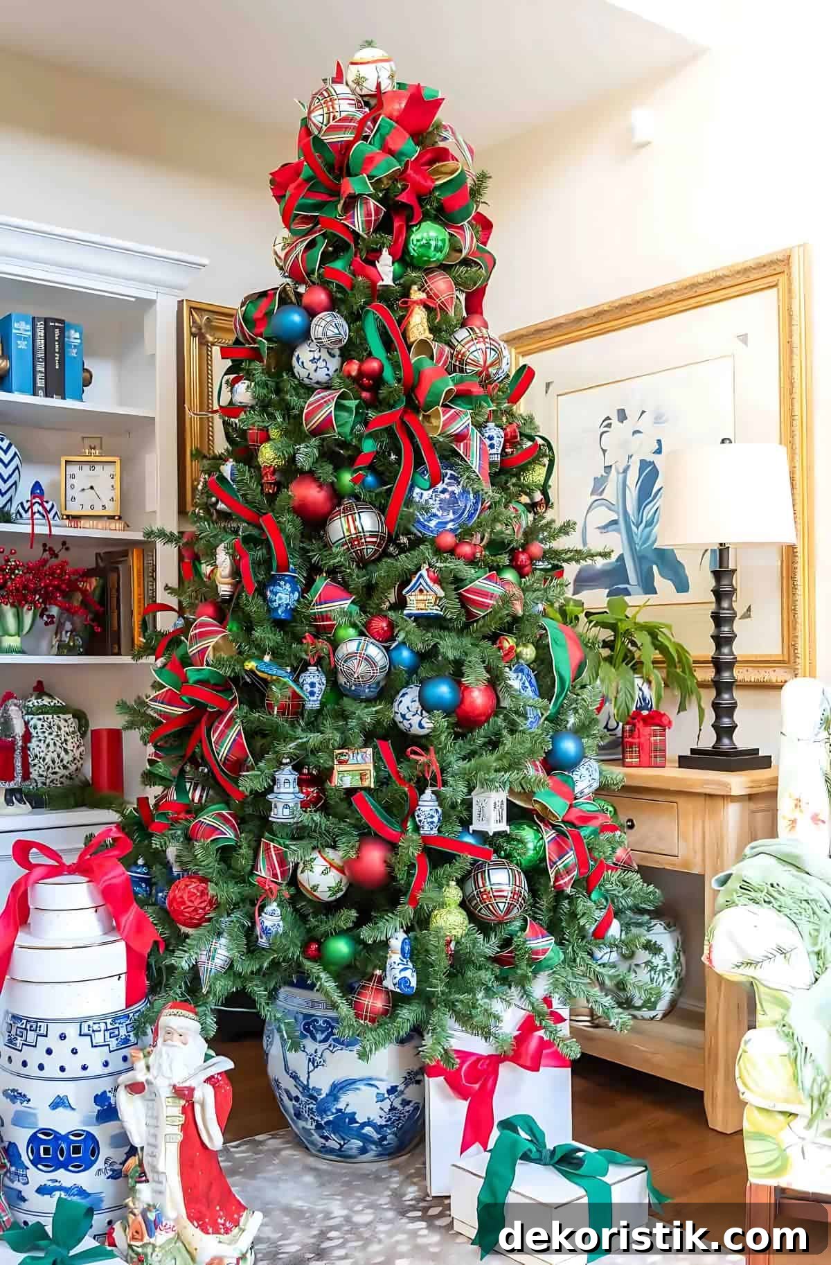 Chinoiserie Christmas tree decorated with red and green ornaments and blue and white Chinoiserie ornaments and tartan plaid ribbon