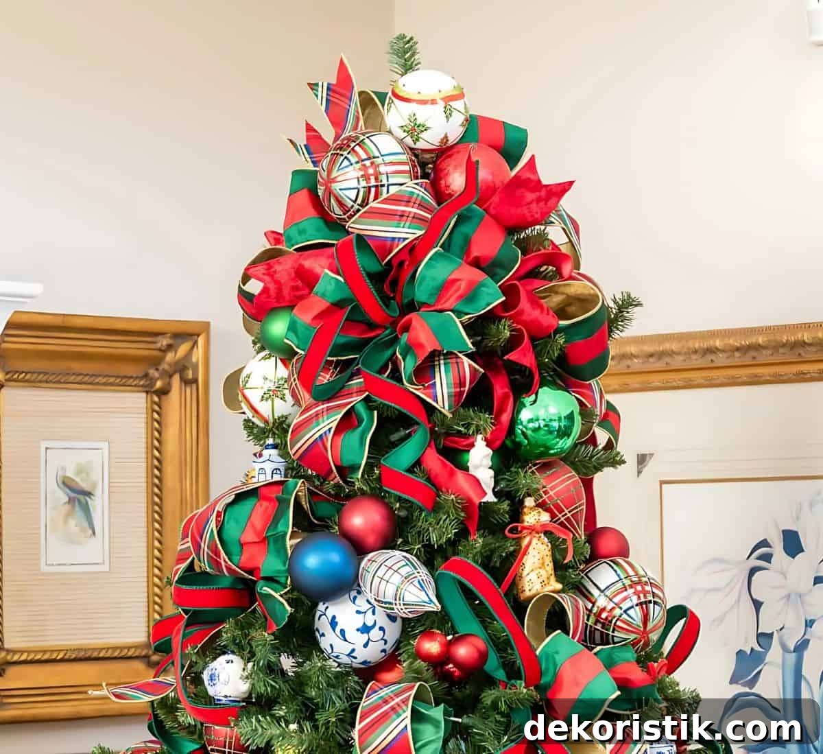 top of Christmas tree decorated with red and green ornaments and plaid ribbon