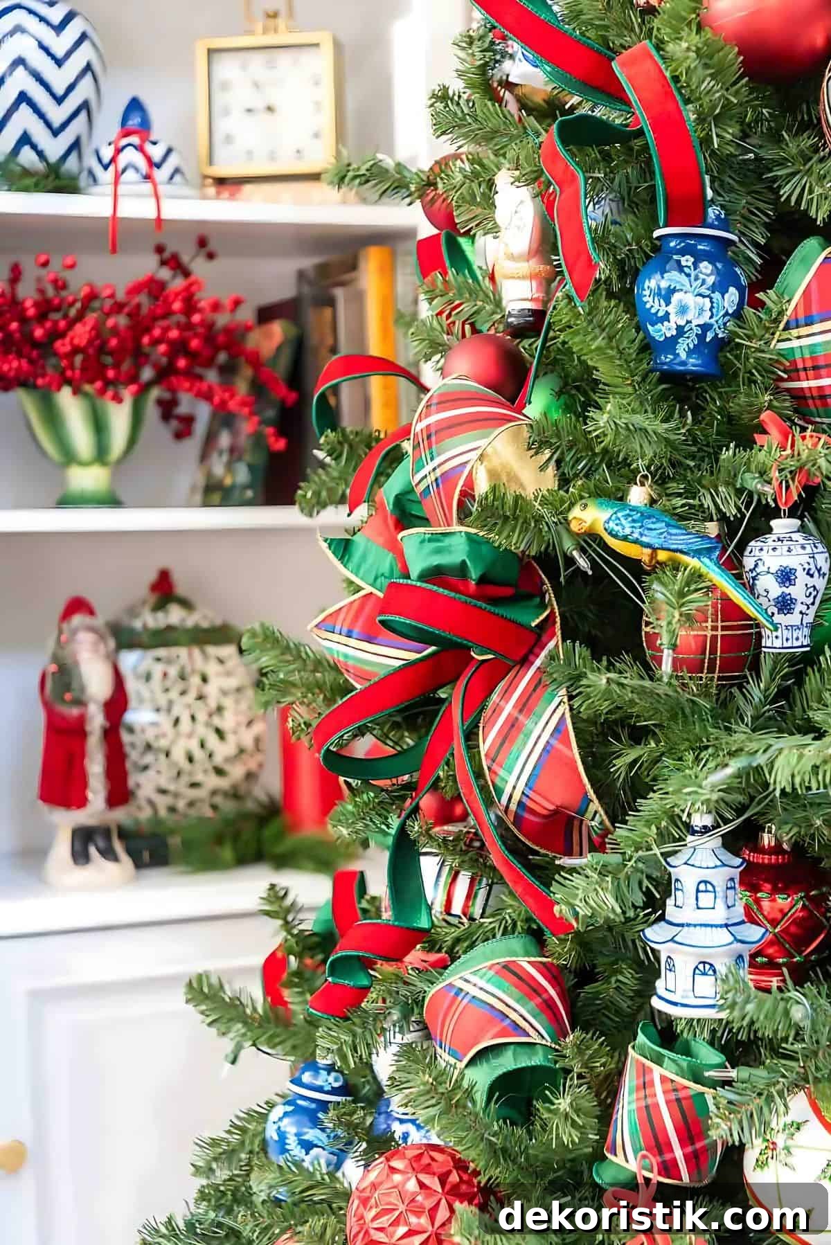 Chinoiserie Christmas tree decorated with red and green ornaments and blue and white Chinoiserie ornaments and tartan plaid ribbon