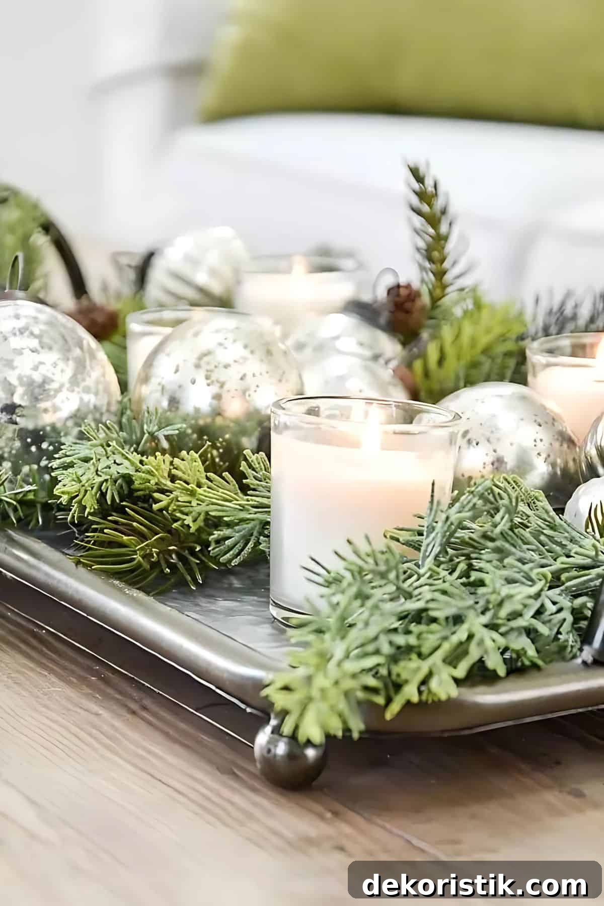silver tray filled with greenery and white candles