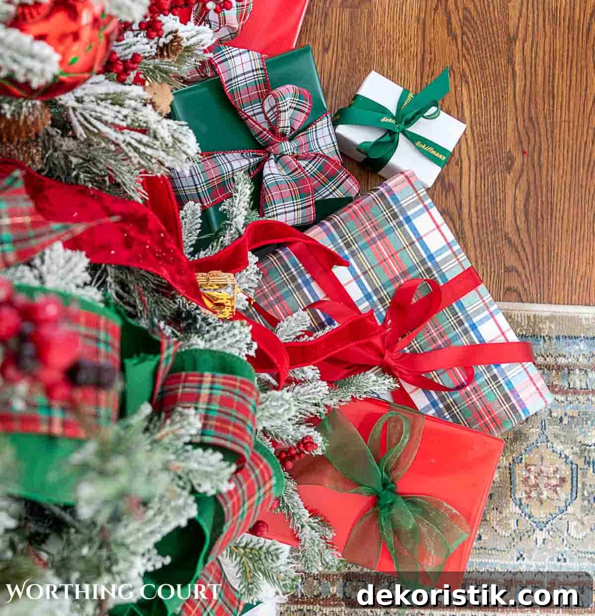 Christmas tree, fireplace and living room decorated for Christmas with red green and gold decorations