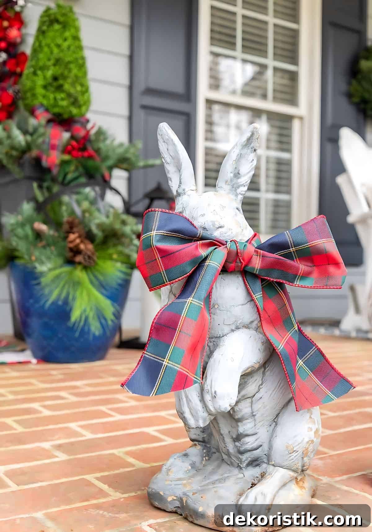 concrete bunny with a Christmas ribbon bow