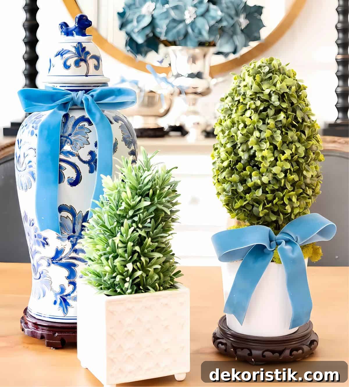 french blue ribbon tied around vase and topiary in a centerpiece