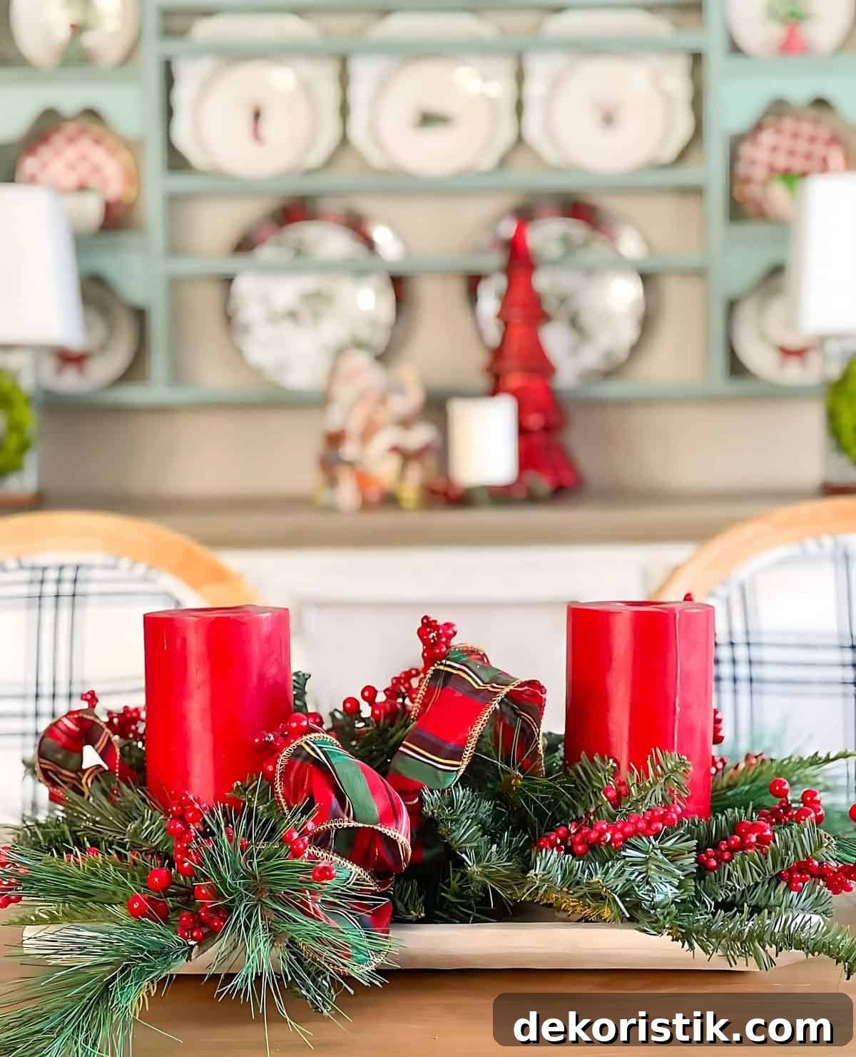 Christmas centerpiece with greenery and large red candles