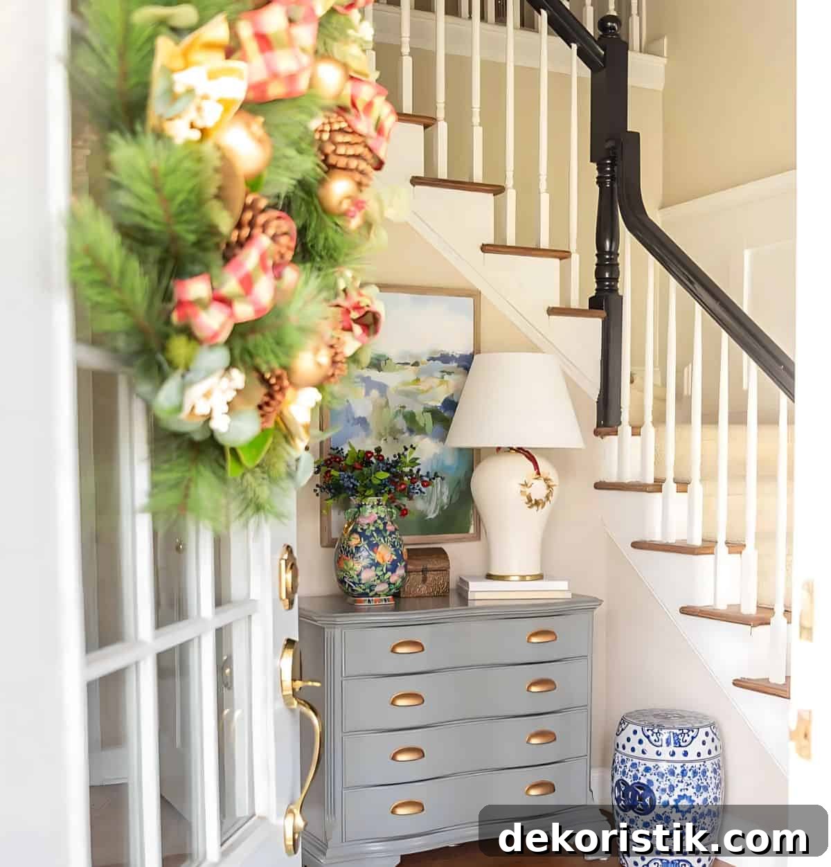 foyer with a gray chest decorated for Christmas