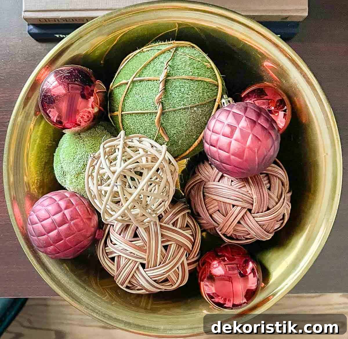brass bowl filled with moss orbs and burgundy Christmas ornaments