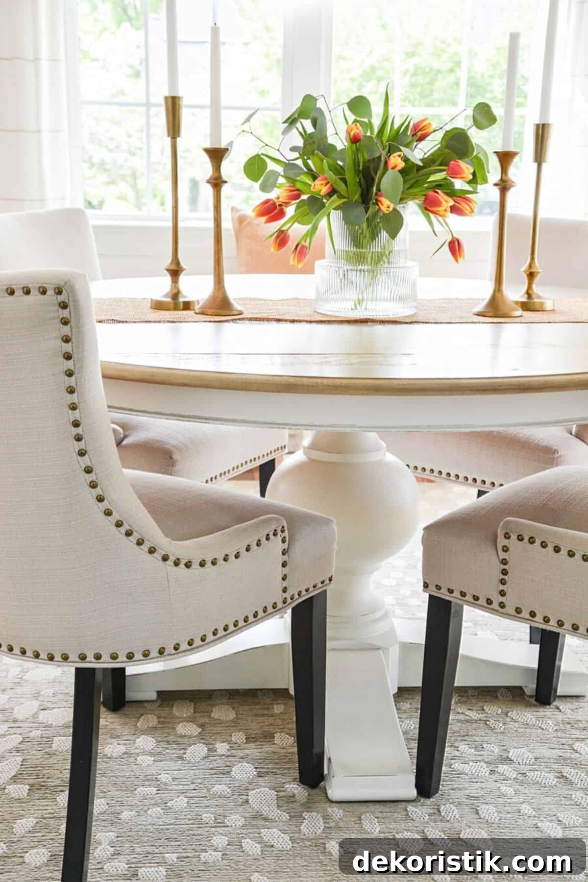 round dining table with 4 neutral upholstered chairs