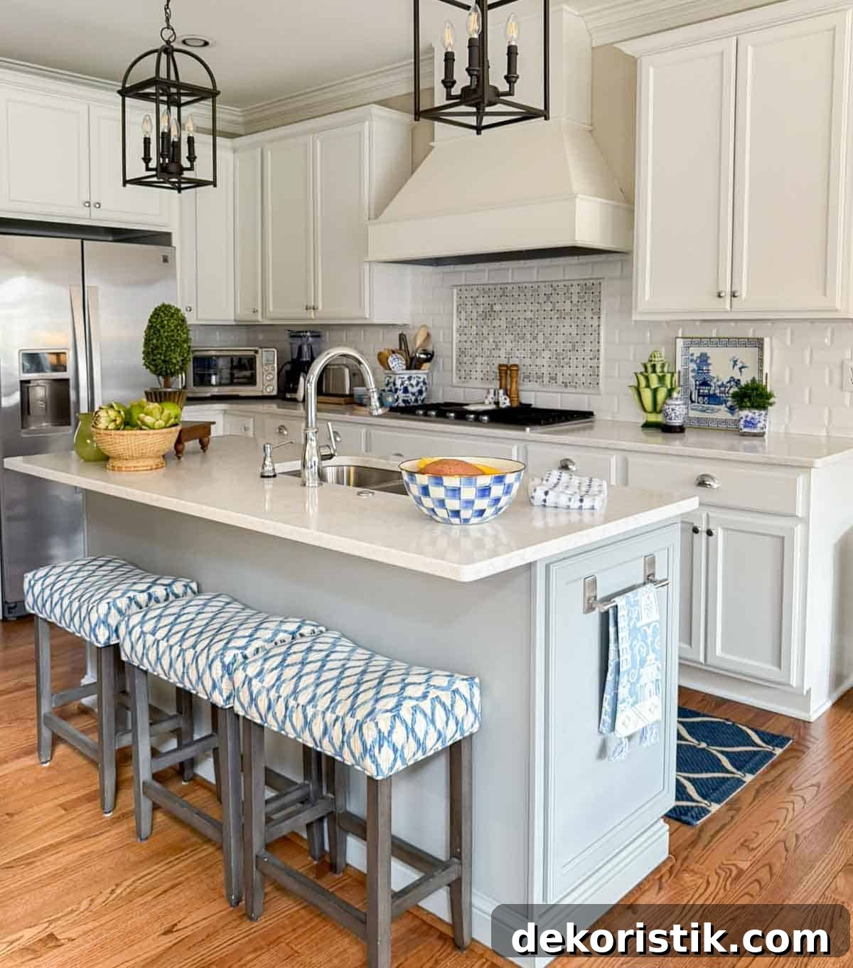 all white kitchen with a gray island and colorful accessories