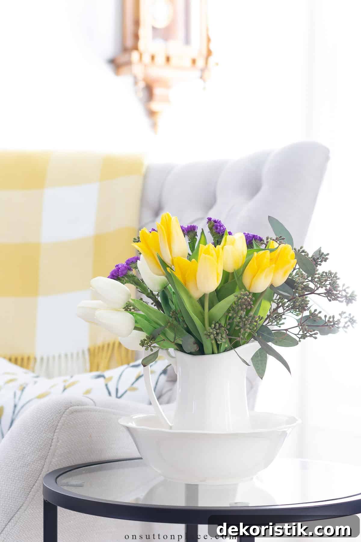 spring flowers in a white pitcher on a side table