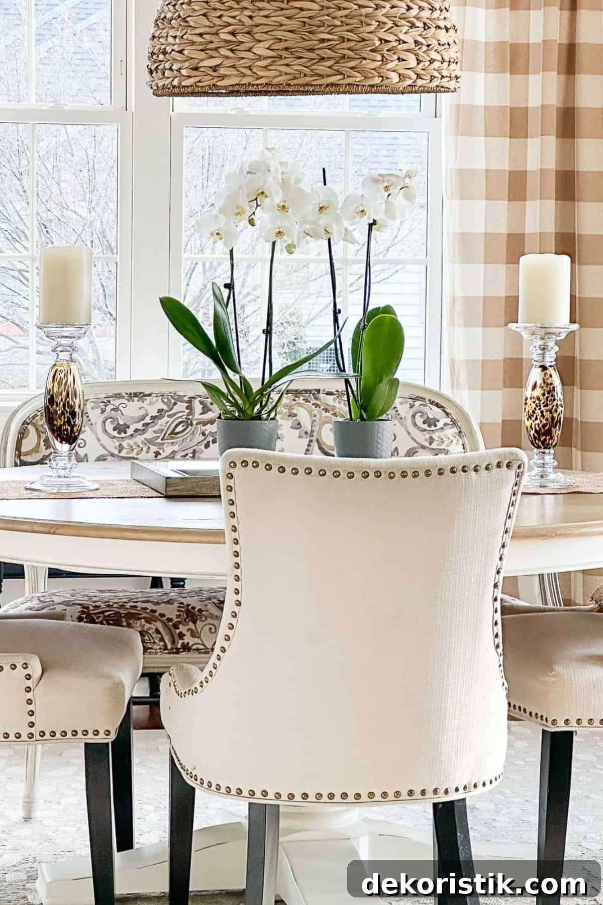 neutral upholstered chairs at a dining table