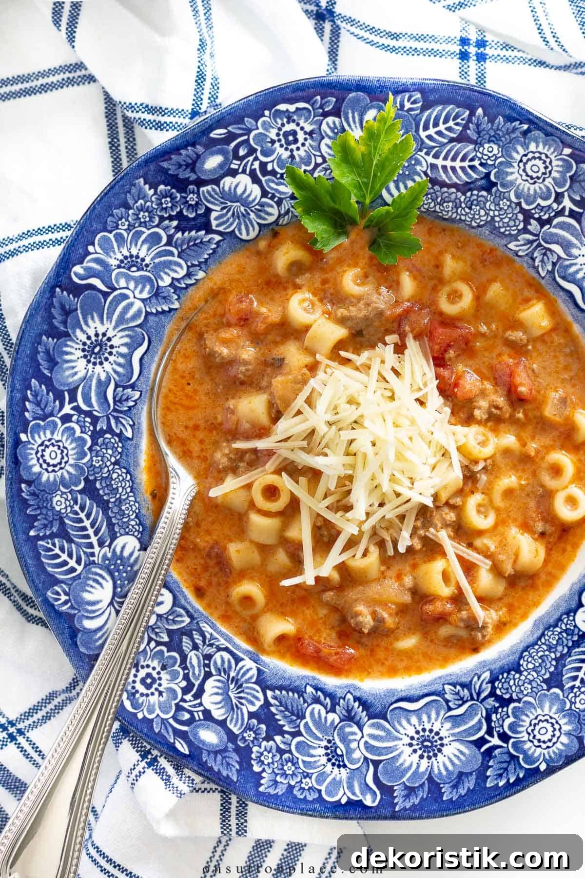 spaghetti soup in a bowl with a blue rim