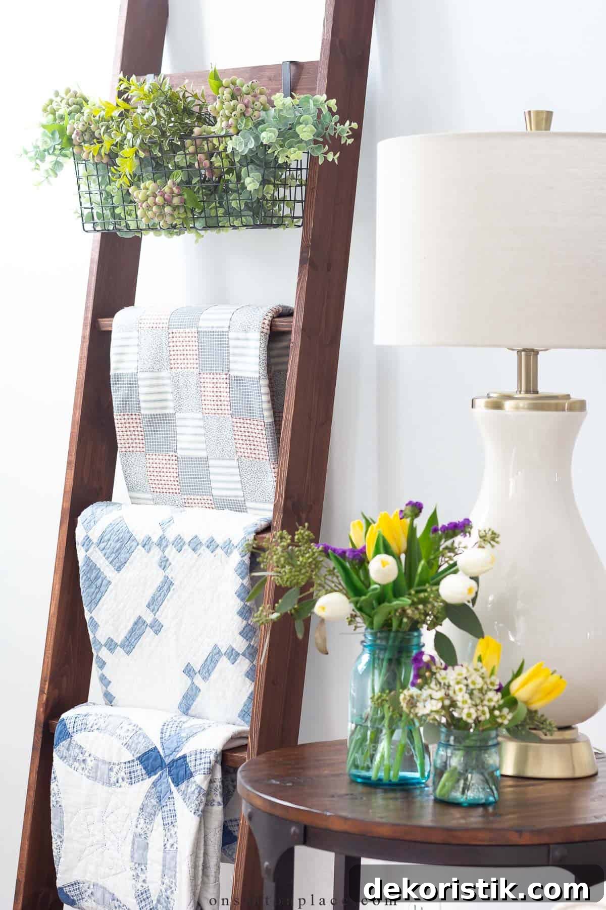 a quilt collection displayed on a wood ladder