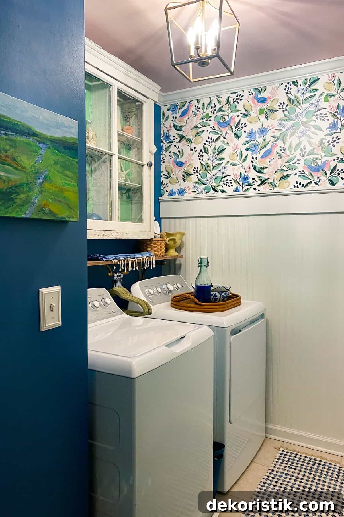 laundry room with colorful wallpaper, blue paint, and vintage decor