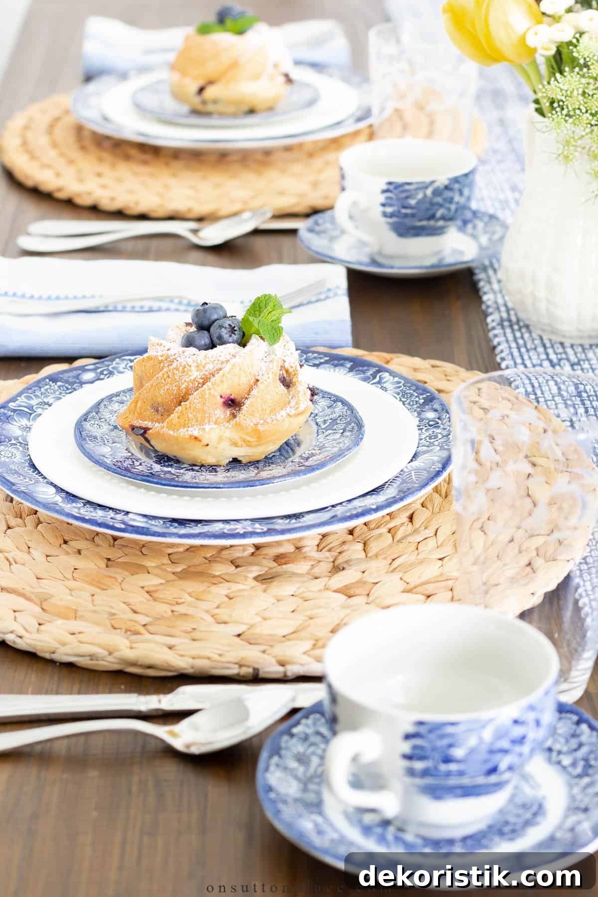 blue and white plates and cups on a raffia placemat