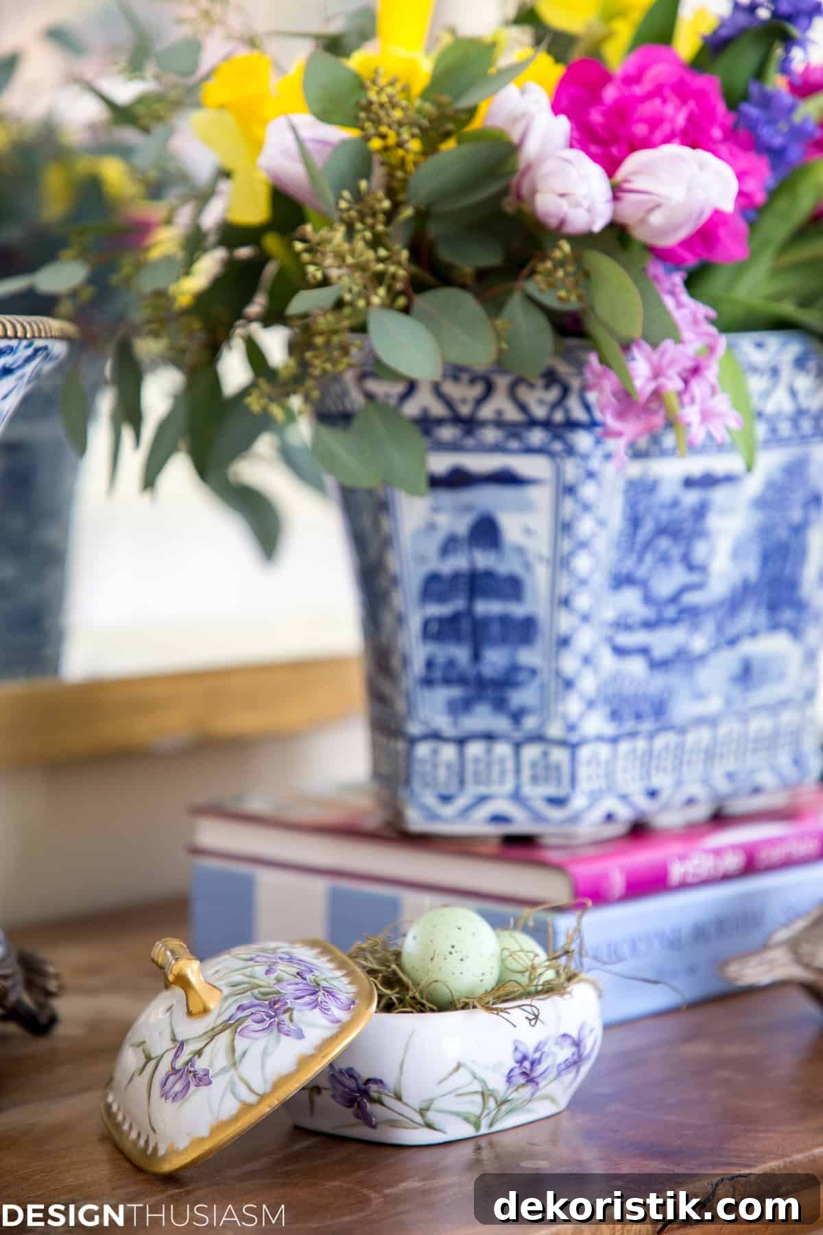 blue and white chinoiserie planter with spring flowers in a spring vignette