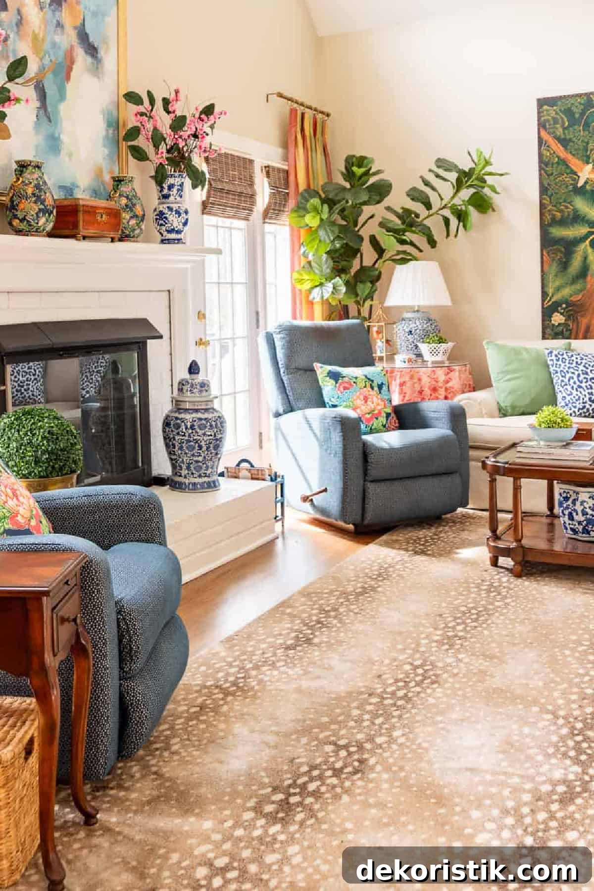 sideways view of a brick fireplace flanked by blue chairs on an antelope print rug