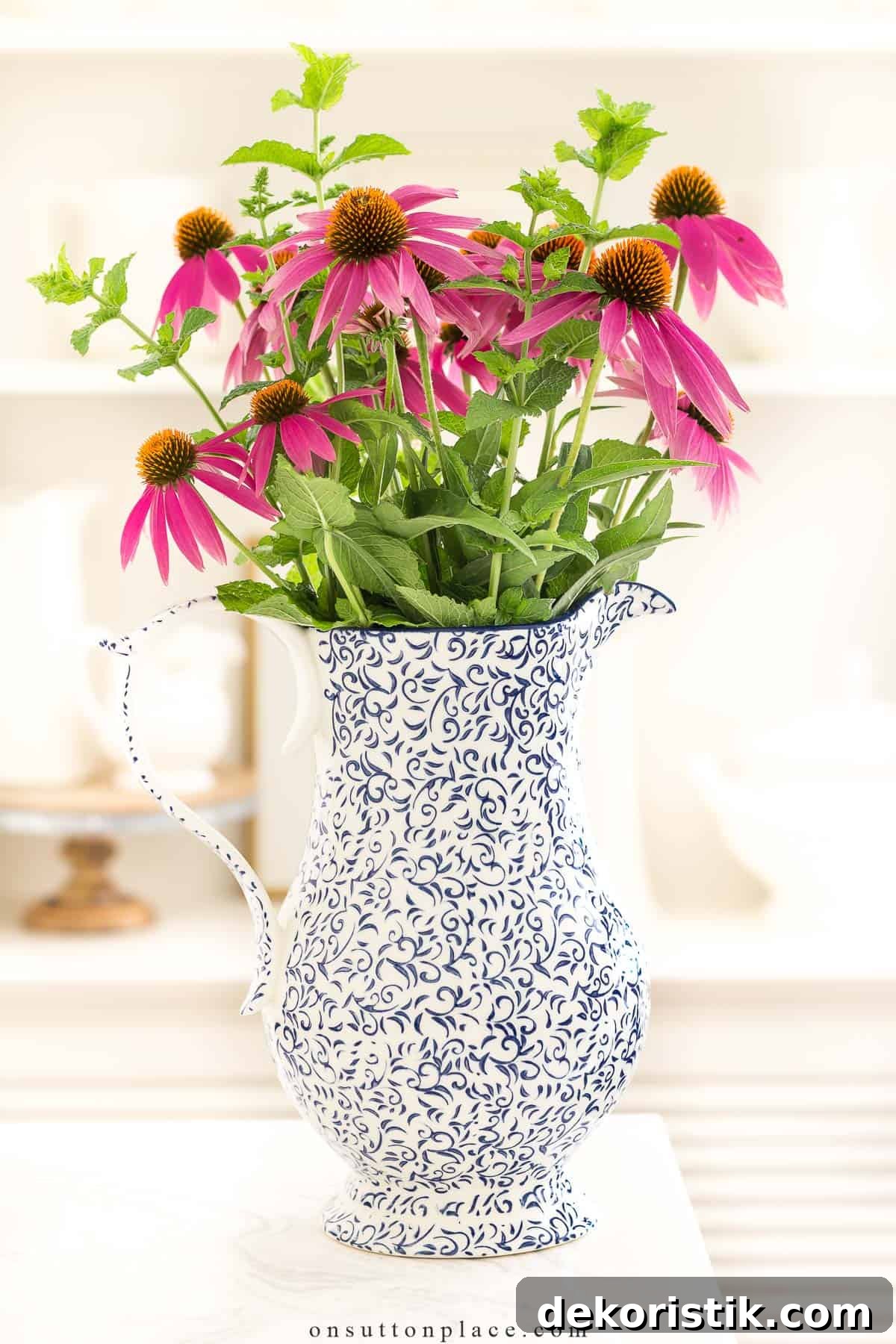 Breezy Summer Decor Ideas and Garden Favorites 4 blue and white pitcher filled with a bunch of pink conehead flowers