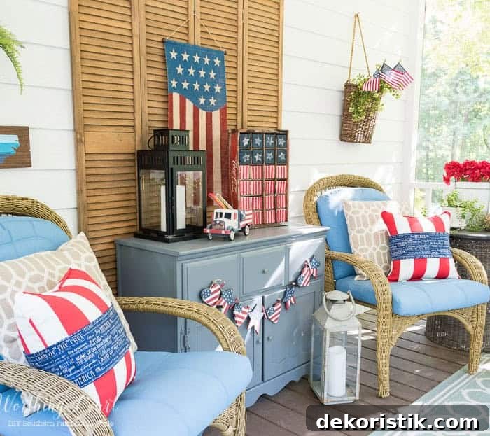 July 4th decorations on a back porch with blue arm chairs flanking a gray chest