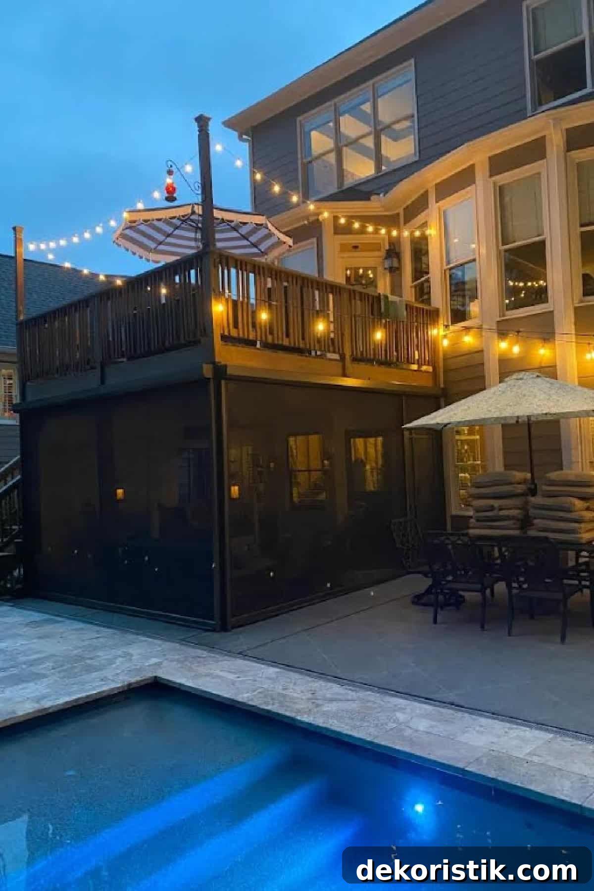 nighttime image of deck with screen porch underneath