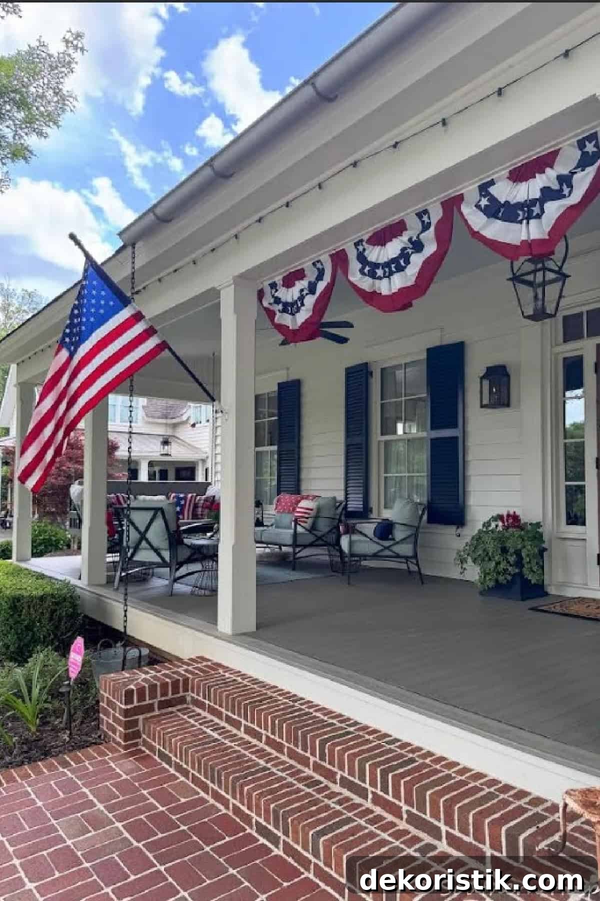front porch with patriotic bunting and an American flag 