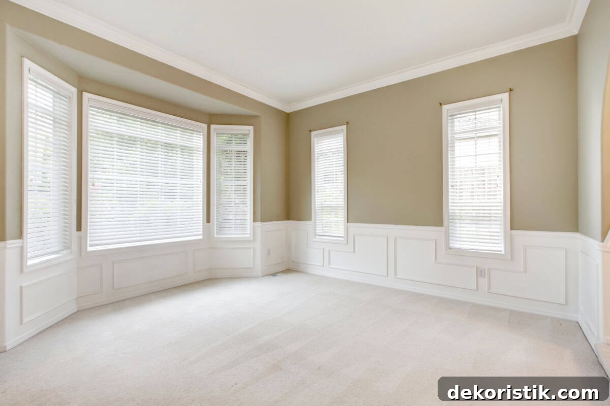 empty living room with beige walls and off white carpeting