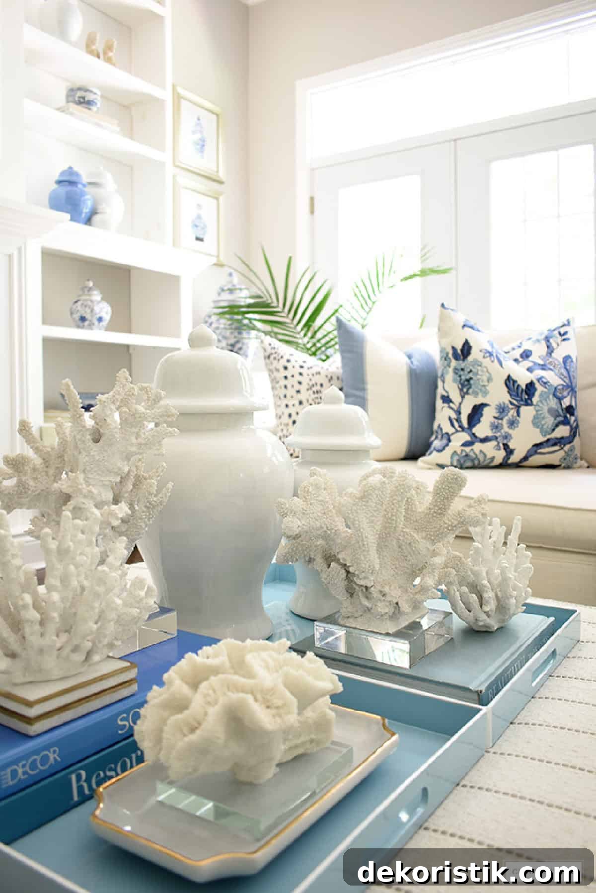 blue and white coastal style decor in an elegant living room with white walls
