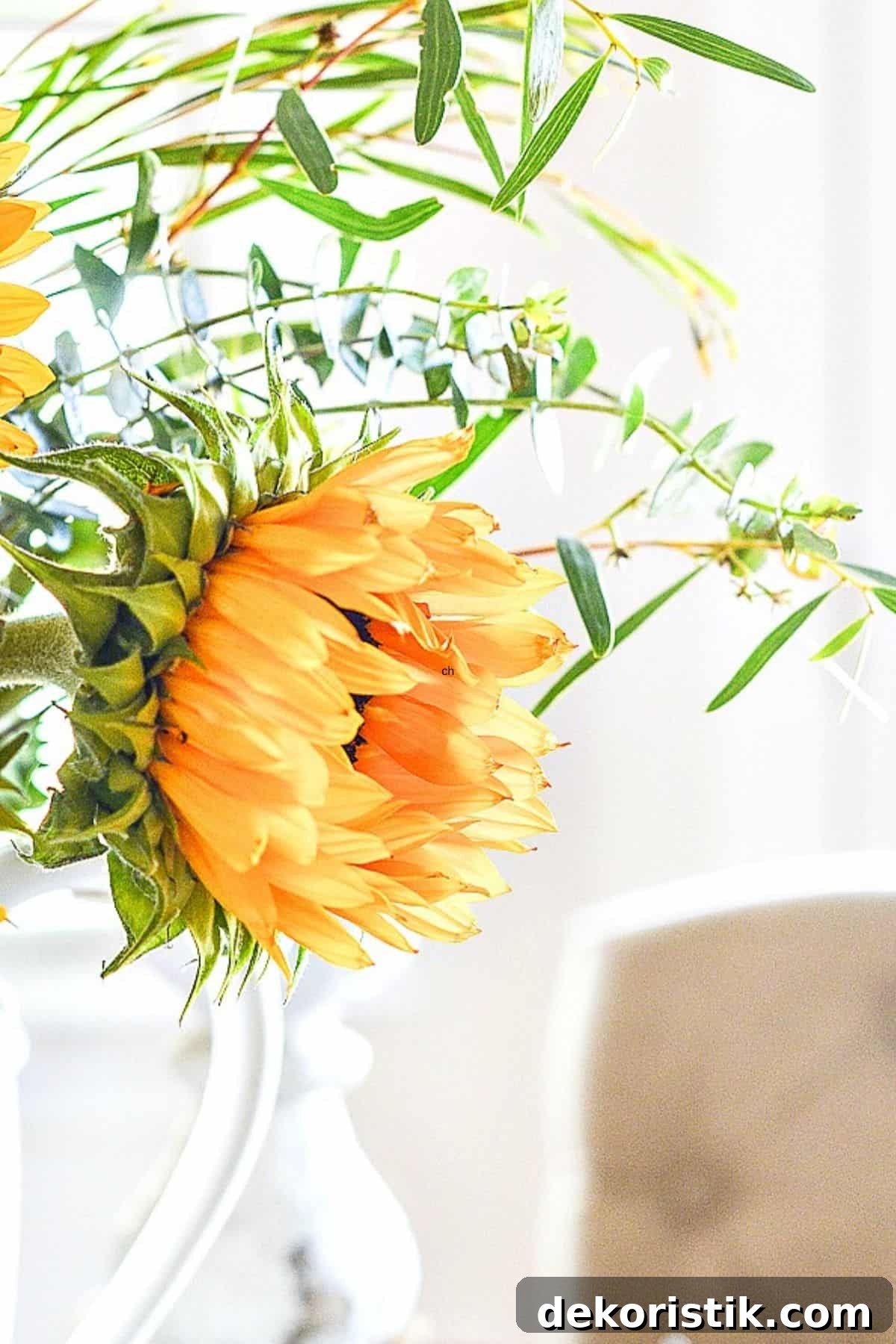 partial view of an arrangement with a partially opened sunflower blossom