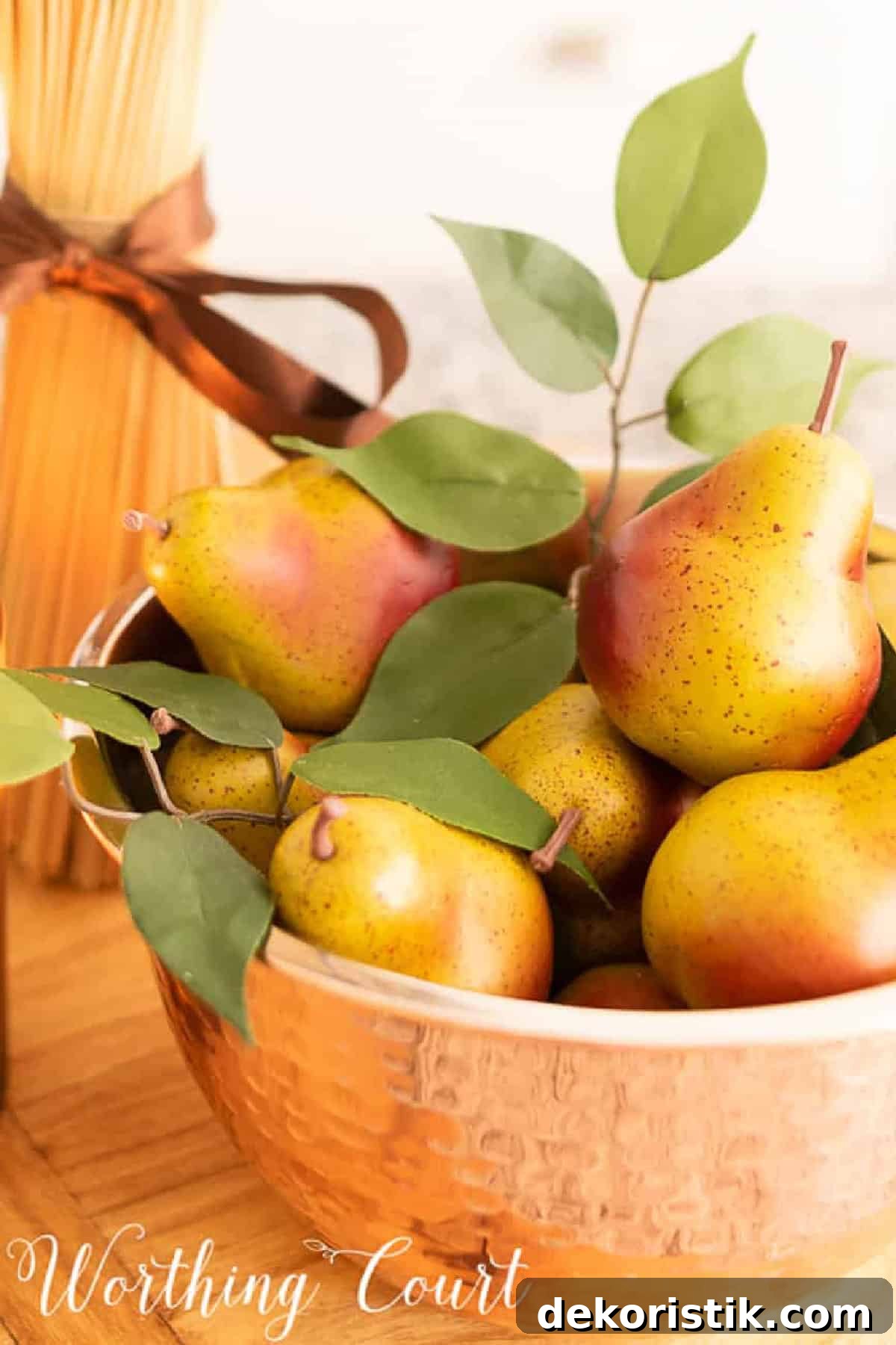 copper bowl filled with small faux pears