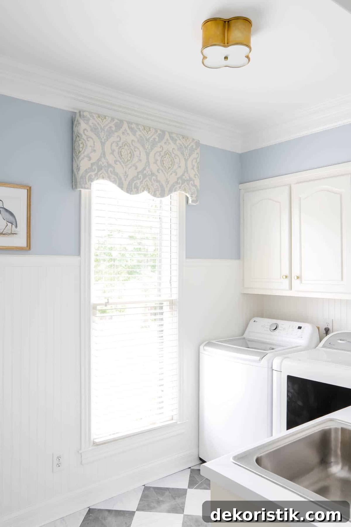 laundry room with white cabinets and medium blue walls with a matching diy window cornice