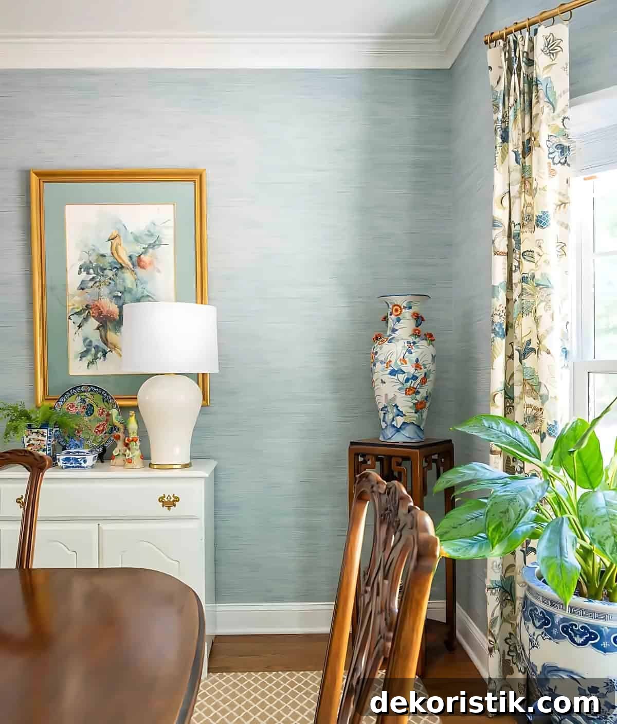 partial view of a dining room with blue grasscloth wallpaper and traditional decor