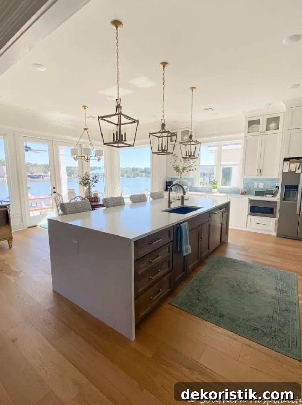kitchen with a large gray island in an open floor plan house overlooking a lake