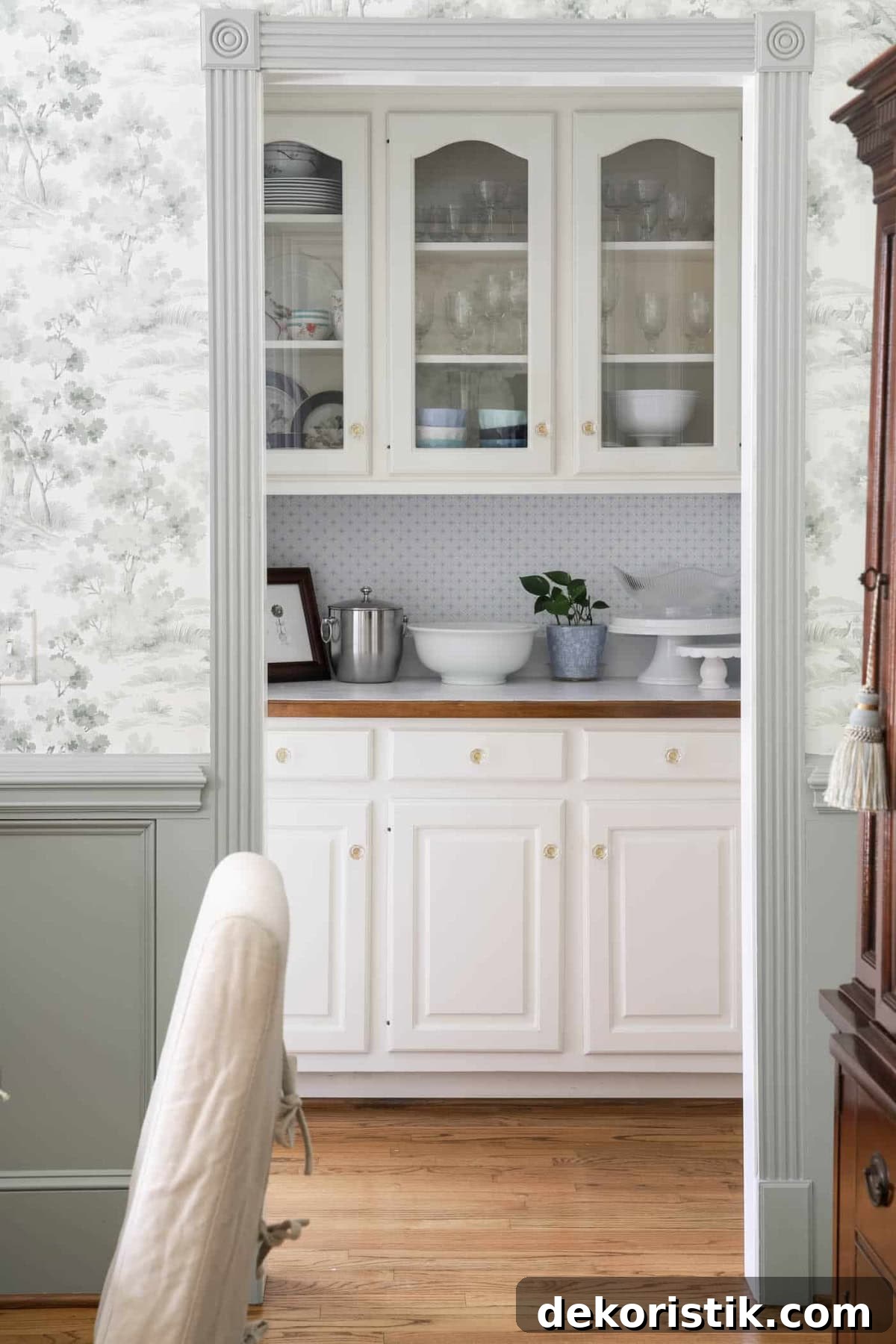 Butler's pantry with glass-front cabinets displaying dishes