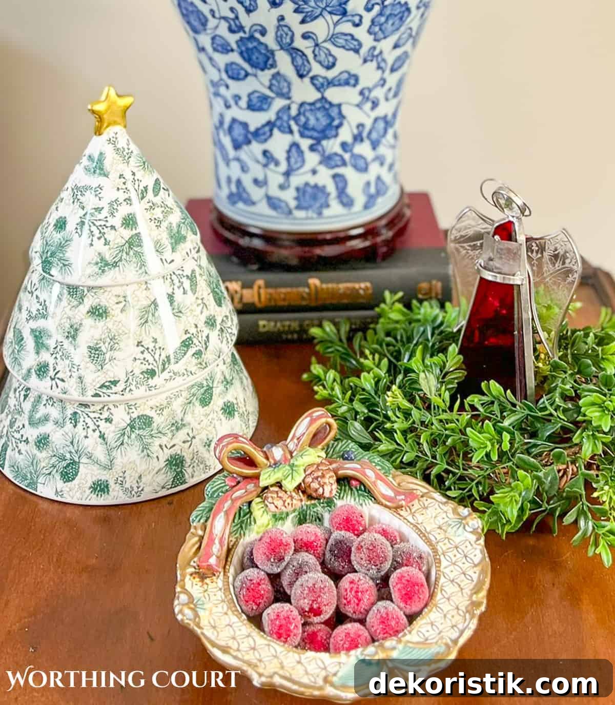Dining room with traditional wood furniture decorated for Christmas with sage green, burgundy, and gold decorations.