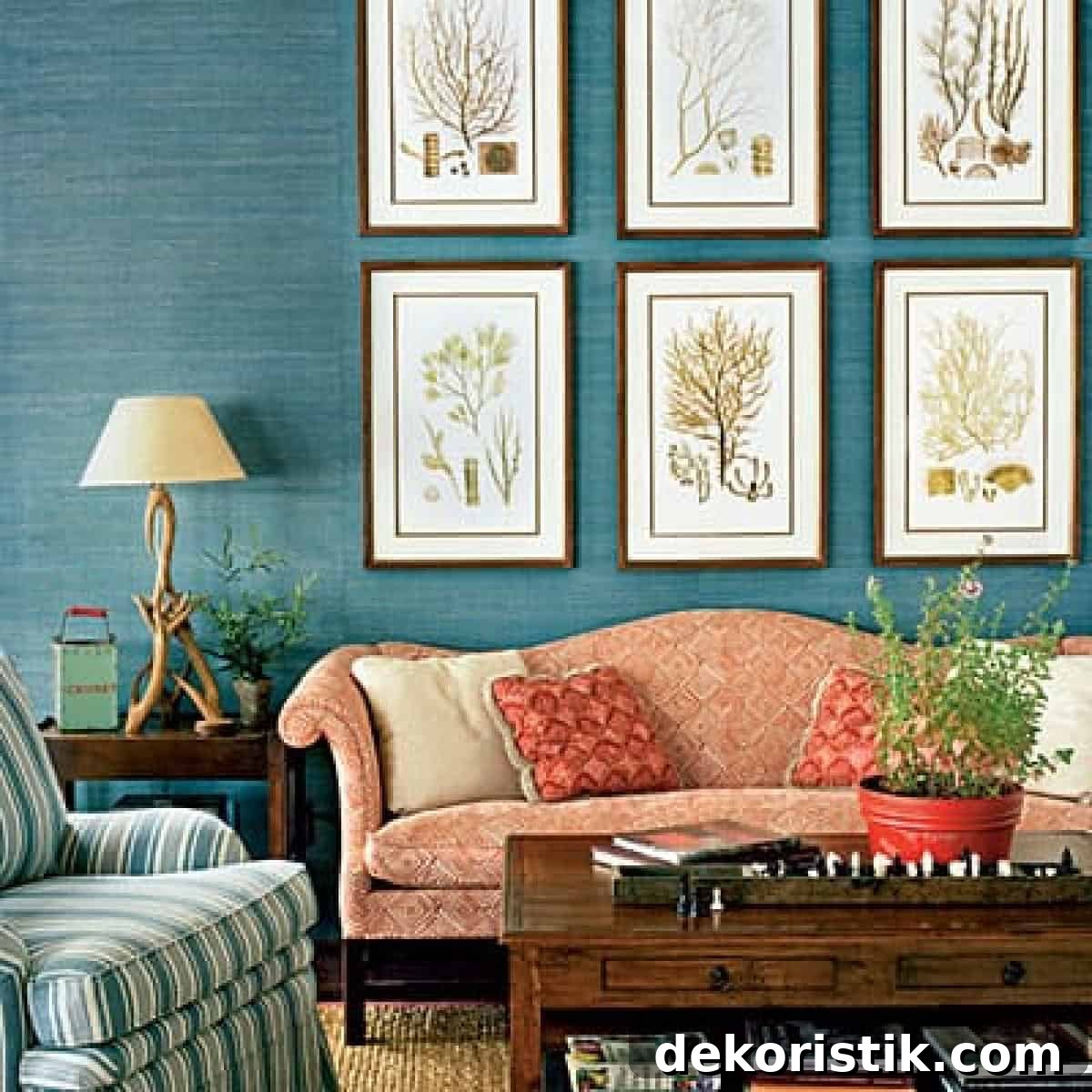 living room with blue walls and an arrangement of large artwork above a red sofa