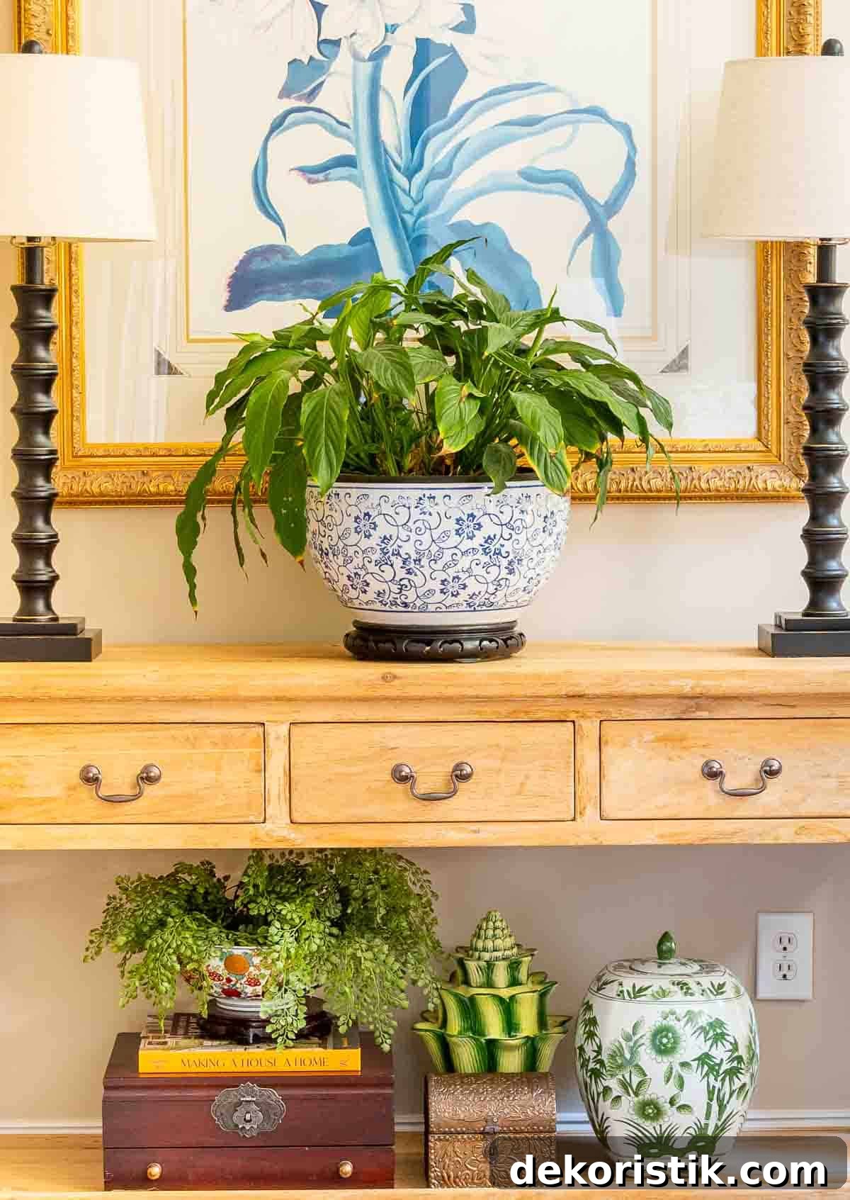 natural wood console table decorated with buffet lamps and chinoiserie accessories