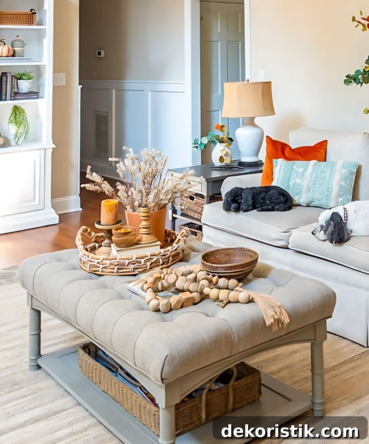 neutral upholstered coffee table with fall decor in a cozy living room