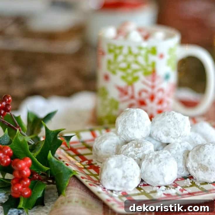 Pecan meltaways on a Christmas plate with holly beside it.