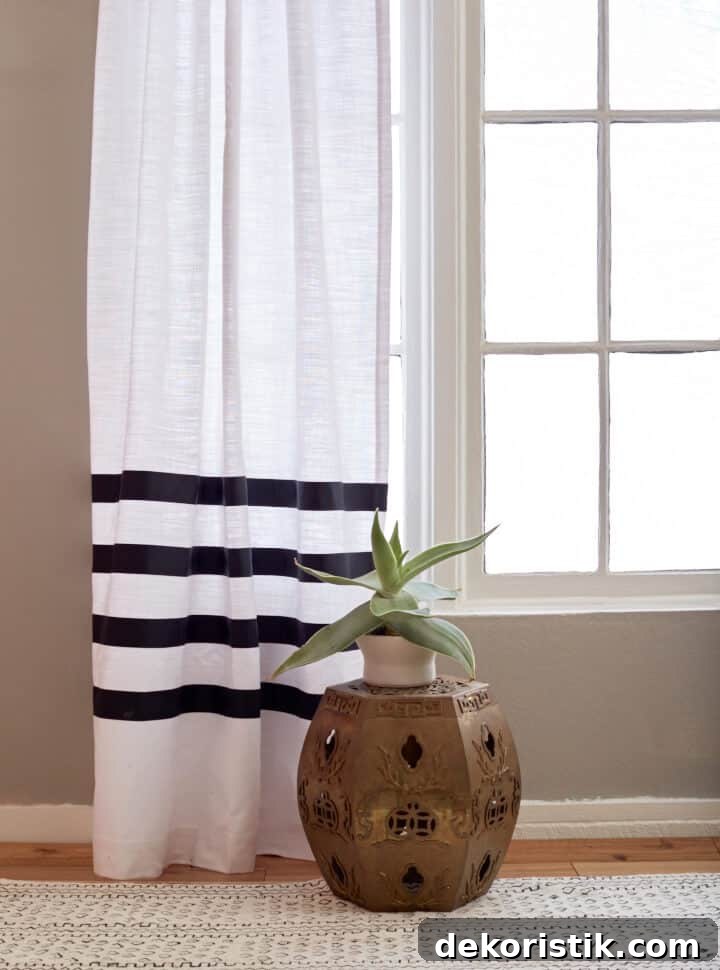 bottom of white drapery panel embellished with grosgrain ribbon