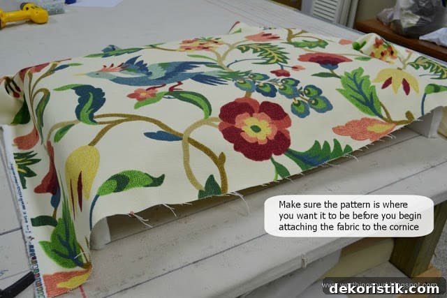 Fabric positioned on cornice